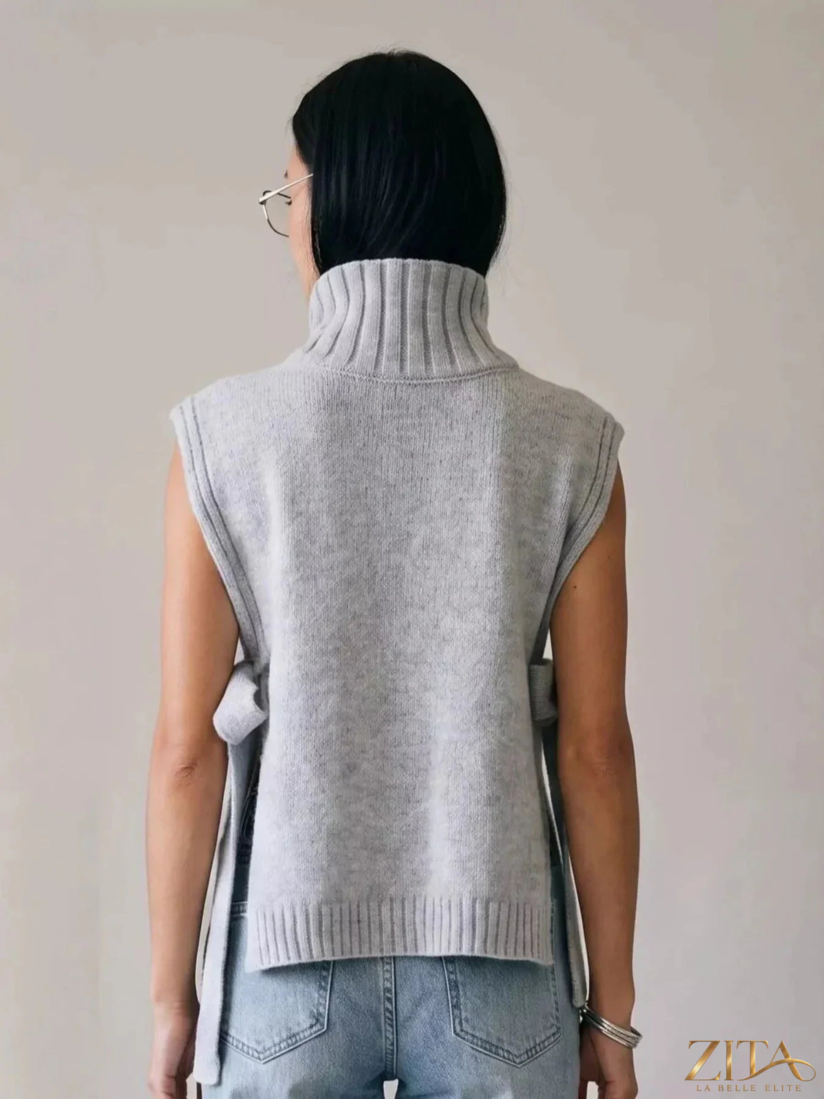 Gray turtleneck side-tie knit sweater vest from Trendsi, featuring a cozy design and stylish side tie detail.