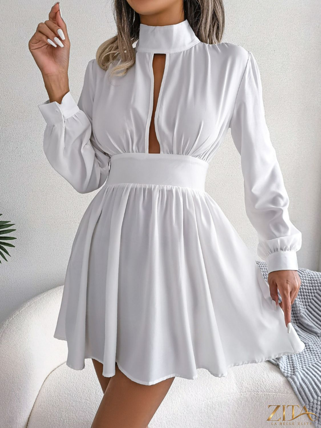Cutout turtleneck A-line mini dress from Trendsi featuring a fitted silhouette and stylish design, shown on a model.