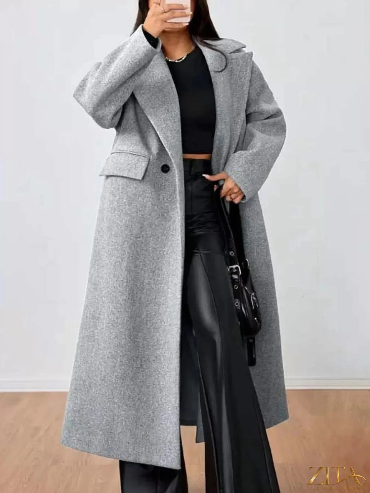 Zita La Belle Elite wool-blend longline overcoat hanging on a wooden hanger, showcasing its tailored fit and classic design.
