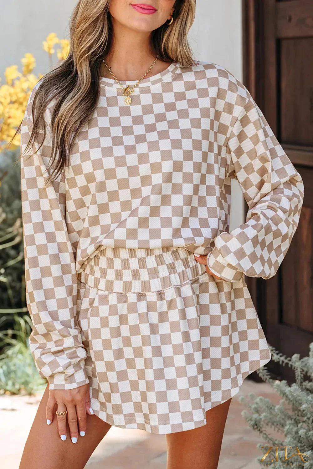 Checkered long sleeve top and skirt two-piece set by Trendsi, featuring a stylish matching design and classic pattern.