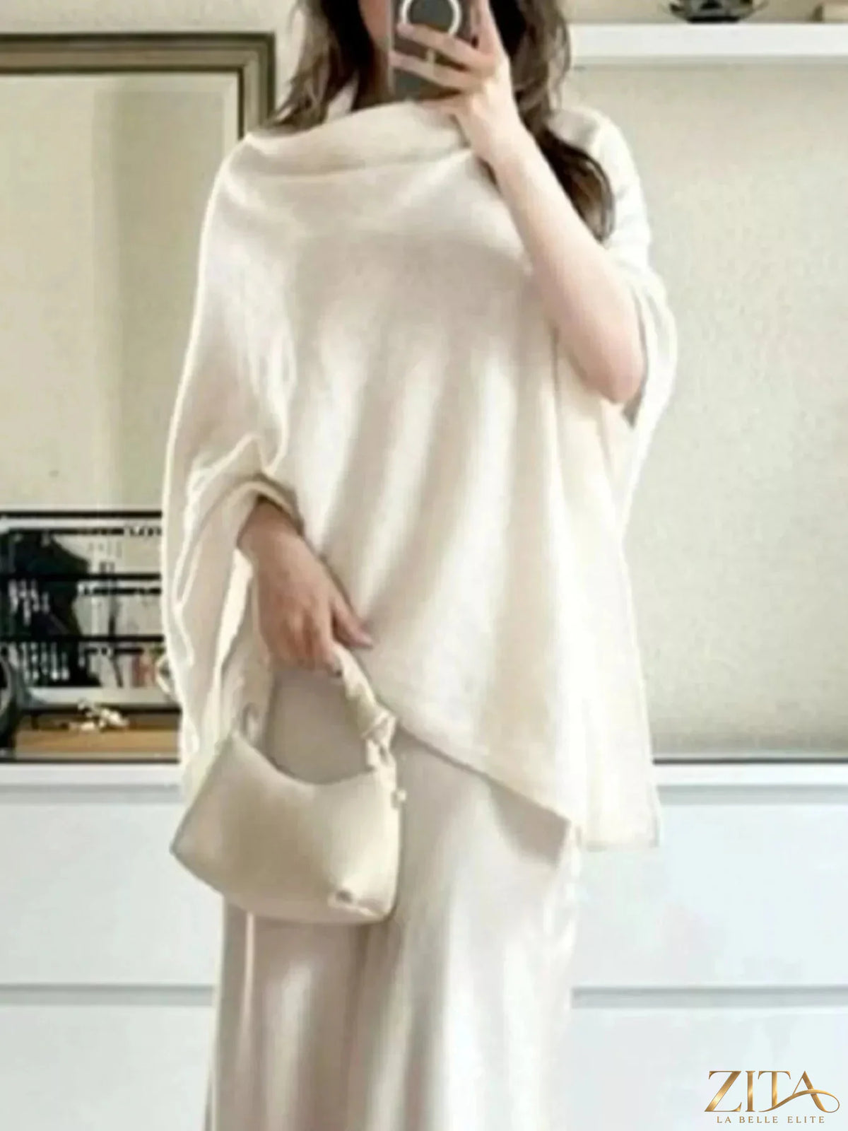Loose knit turtleneck sweater poncho by Trendsi, showcasing cozy, oversized design in soft, textured fabric.