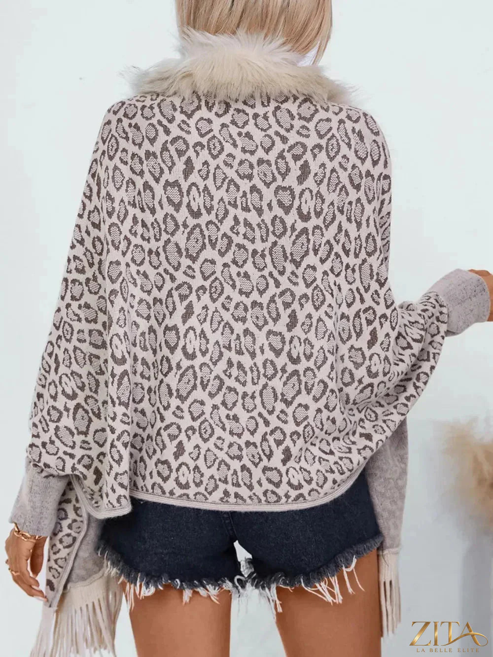Leopard print fringe open front long sleeve poncho by Trendsi, featuring a stylish, flowy design with fringe details.
