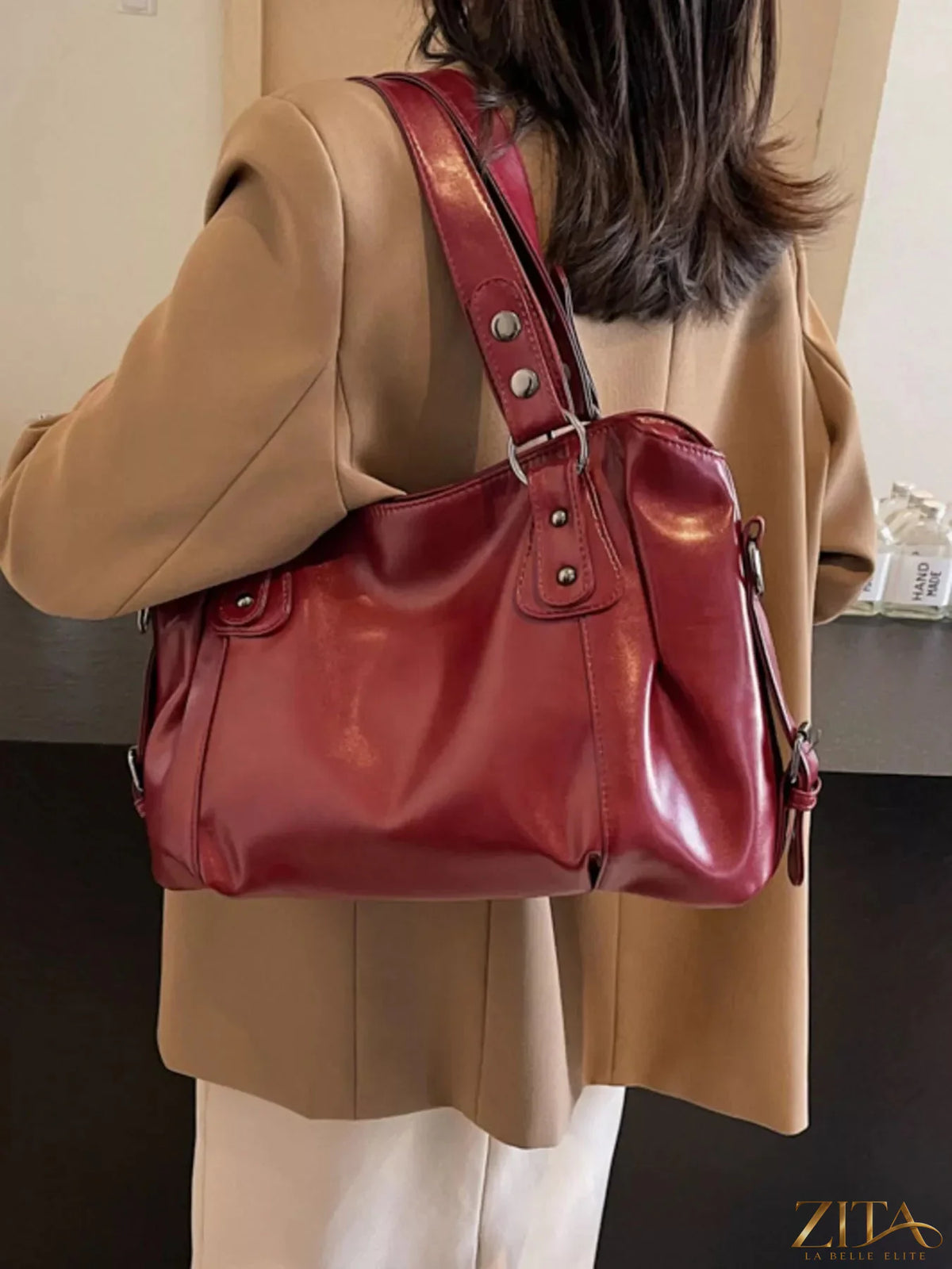 Vintage style leather handbag from Trendsi featuring a classic design with sturdy handles and polished finish.