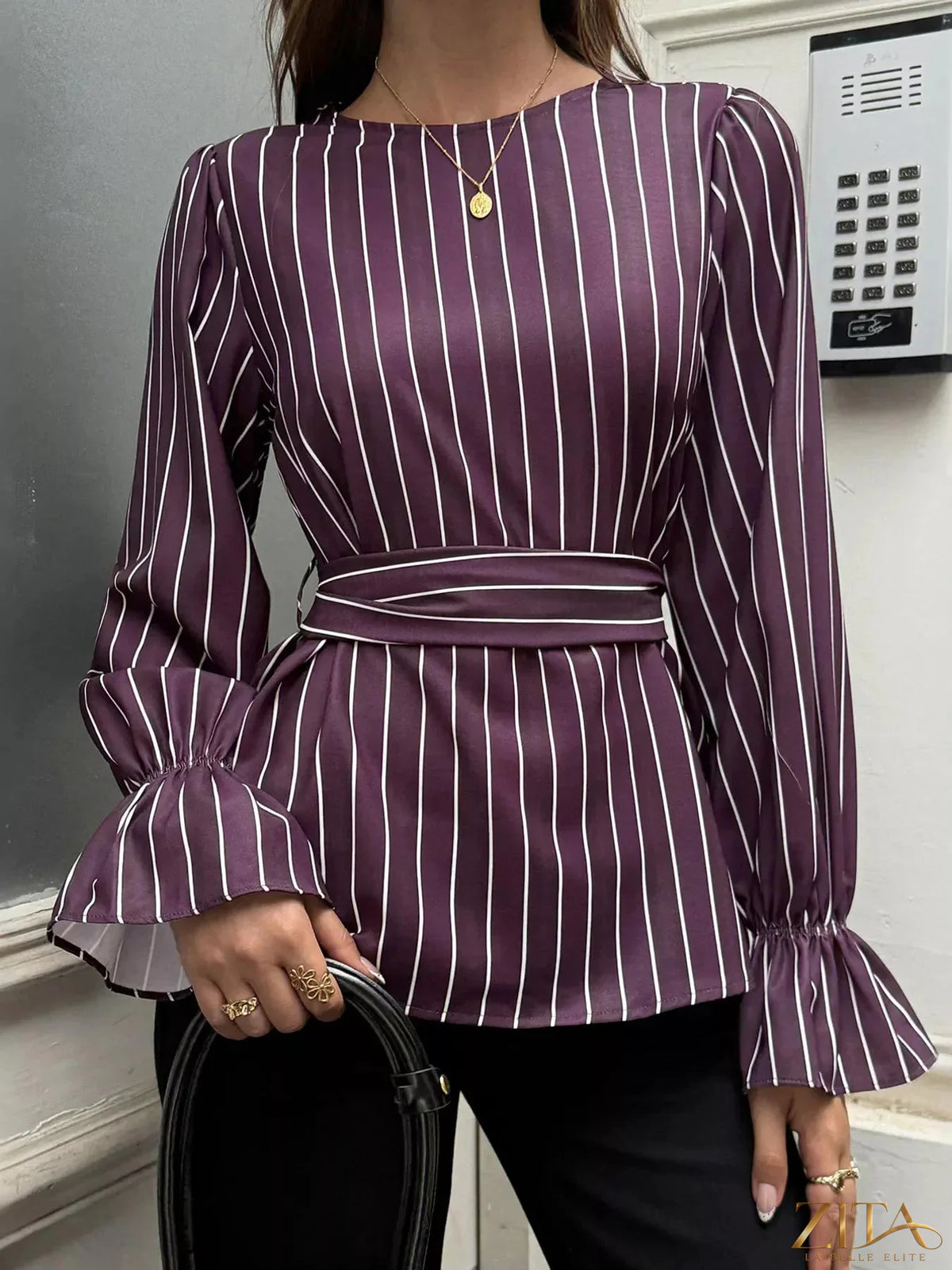 Zita La Belle Elite striped blouse with flounce sleeves, featuring a stylish design and lightweight fabric, shown on a hanger.