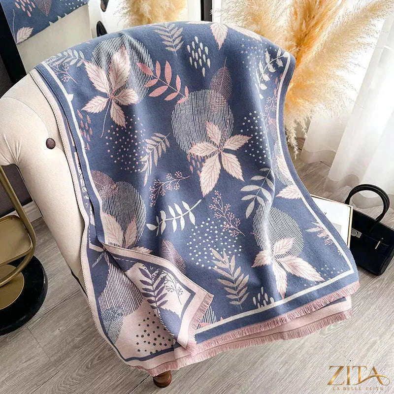 Printed raw hem scarf by Zita La Belle Elite featuring vibrant patterns and fringed edges, styled for a chic, casual look.