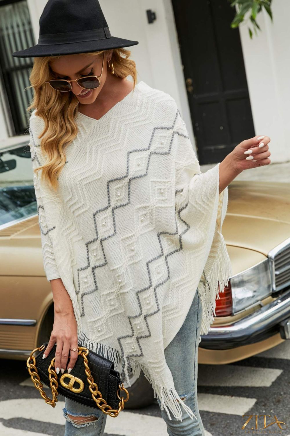 Pearl trim V-neck fringe hem poncho from Trendsi, featuring a stylish V-neck, elegant pearl details, and flowing fringe hem.