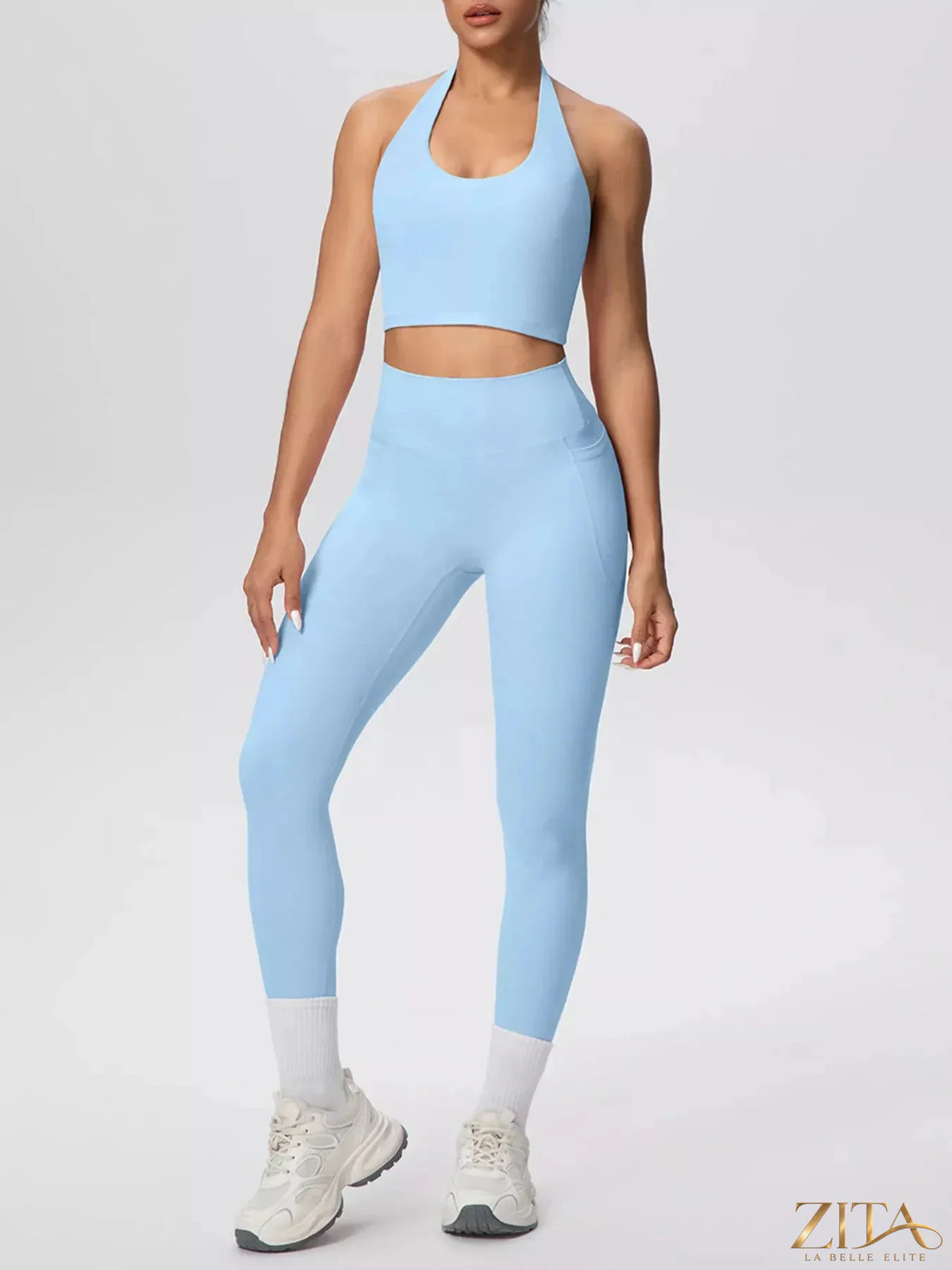 Zita La Belle Elite halter neck crop top and high-waisted leggings active set, shown in black on a model.