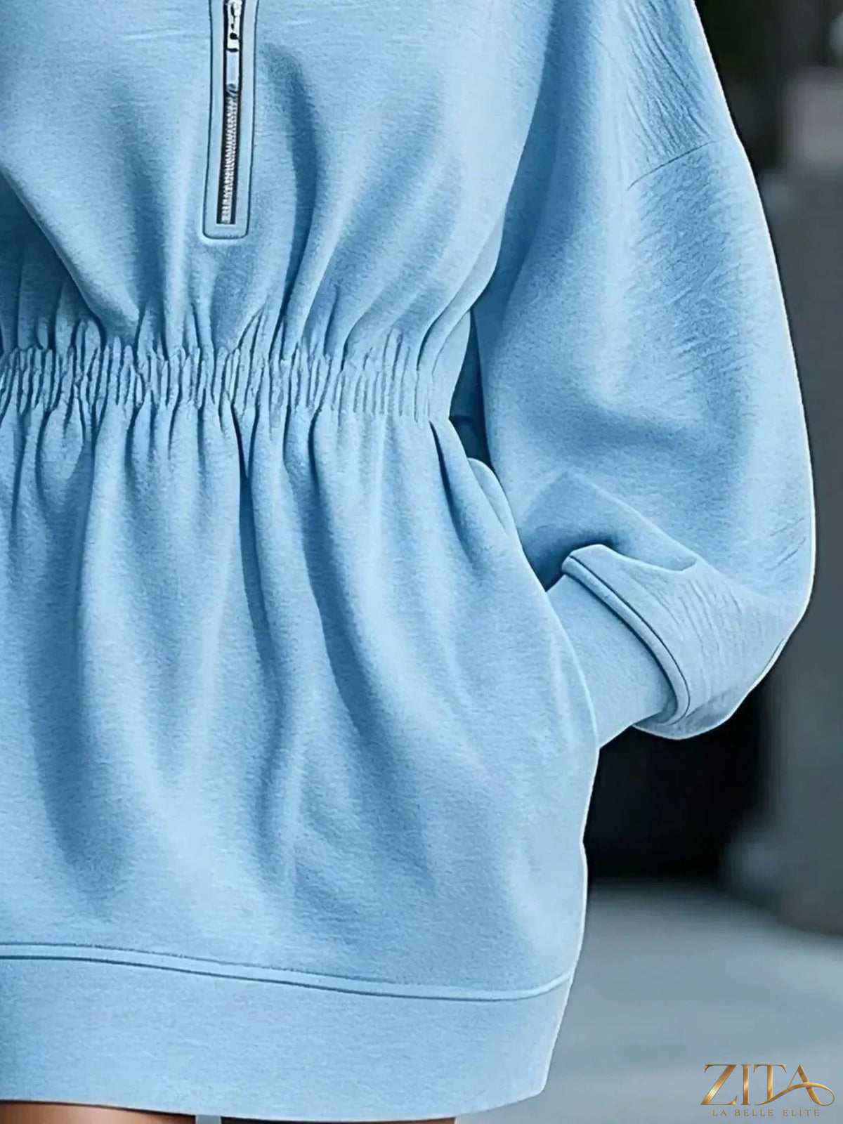 Casual hooded quarter-zip sweatshirt dress by Zita La Belle Elite, featuring a relaxed fit and soft fabric in a neutral color.
