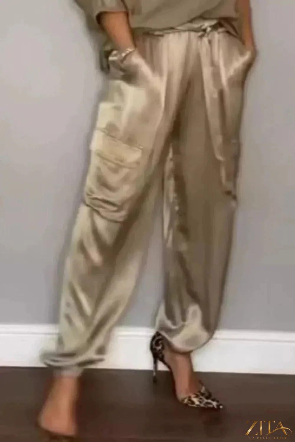 Satin round neck top and matching pants set by Trendsi, featuring a smooth, shiny fabric and comfortable fit.