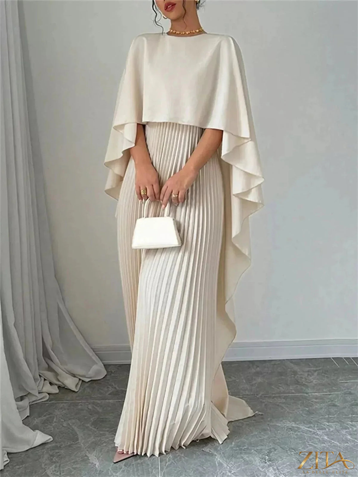 Elegant navy blue Cape Pleated Maxi Dress by Trendsi featuring flowing fabric and a stylish pleated design.