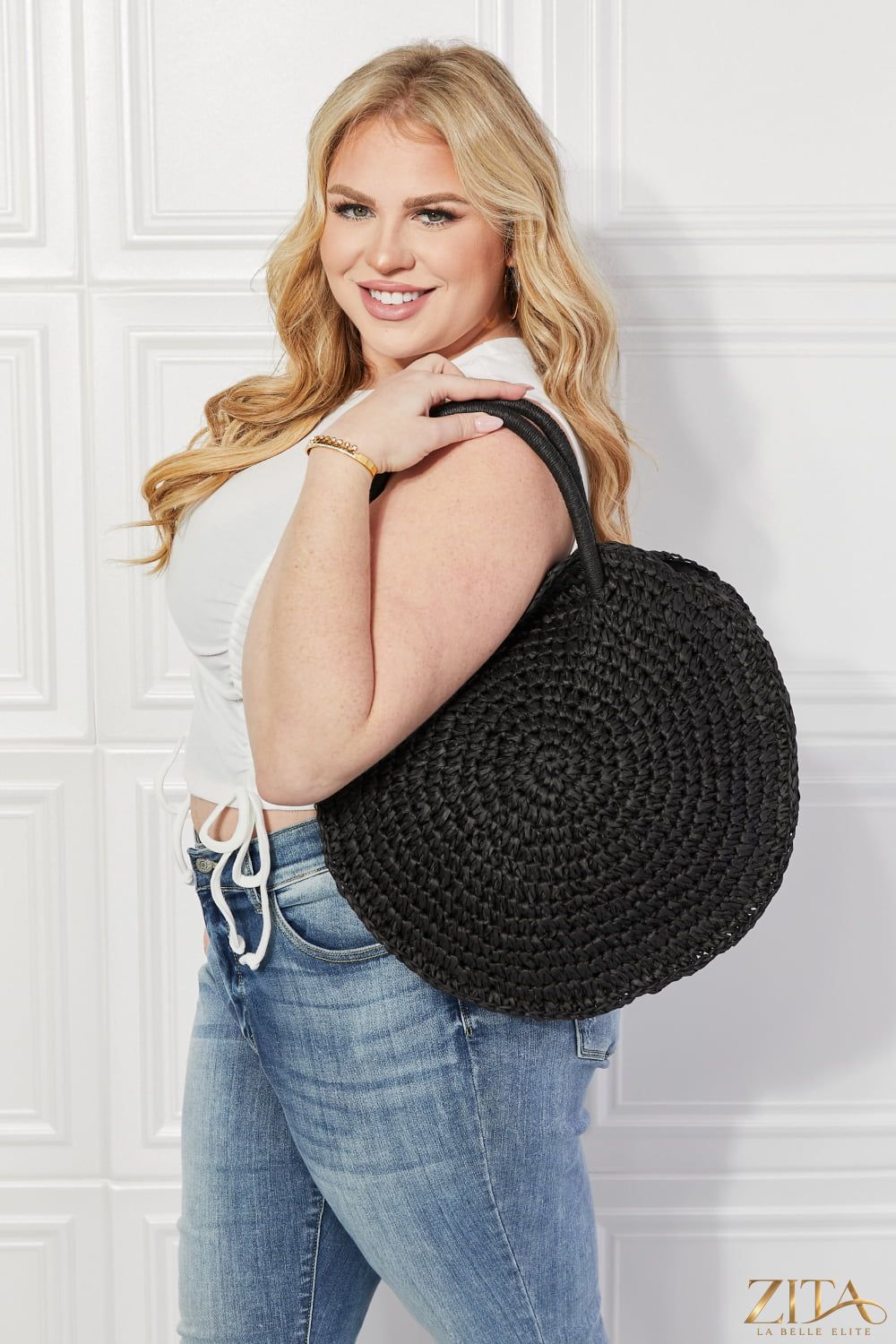 Justin Taylor Beach Date straw rattan handbag in black with a woven handle and stylish design.
