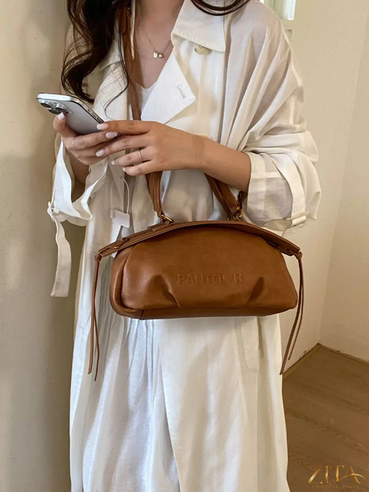 Trendsi PU leather crossbody bag with adjustable strap and gold-tone hardware, showcasing a sleek, modern design.