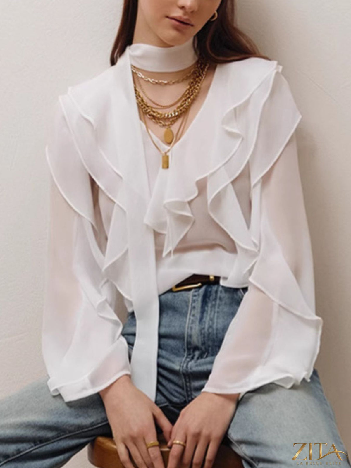 Zita La Belle Elite ruffle trim chiffon blouse featuring flowing fabric, delicate ruffles, and long sleeves on a neutral background.