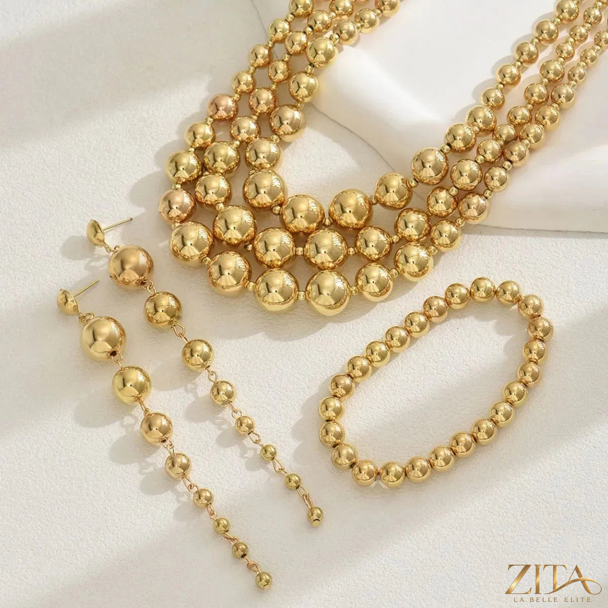 Gold-plated layered beaded jewelry set with multiple strands, featuring elegant beads, by Zita La Belle Elite