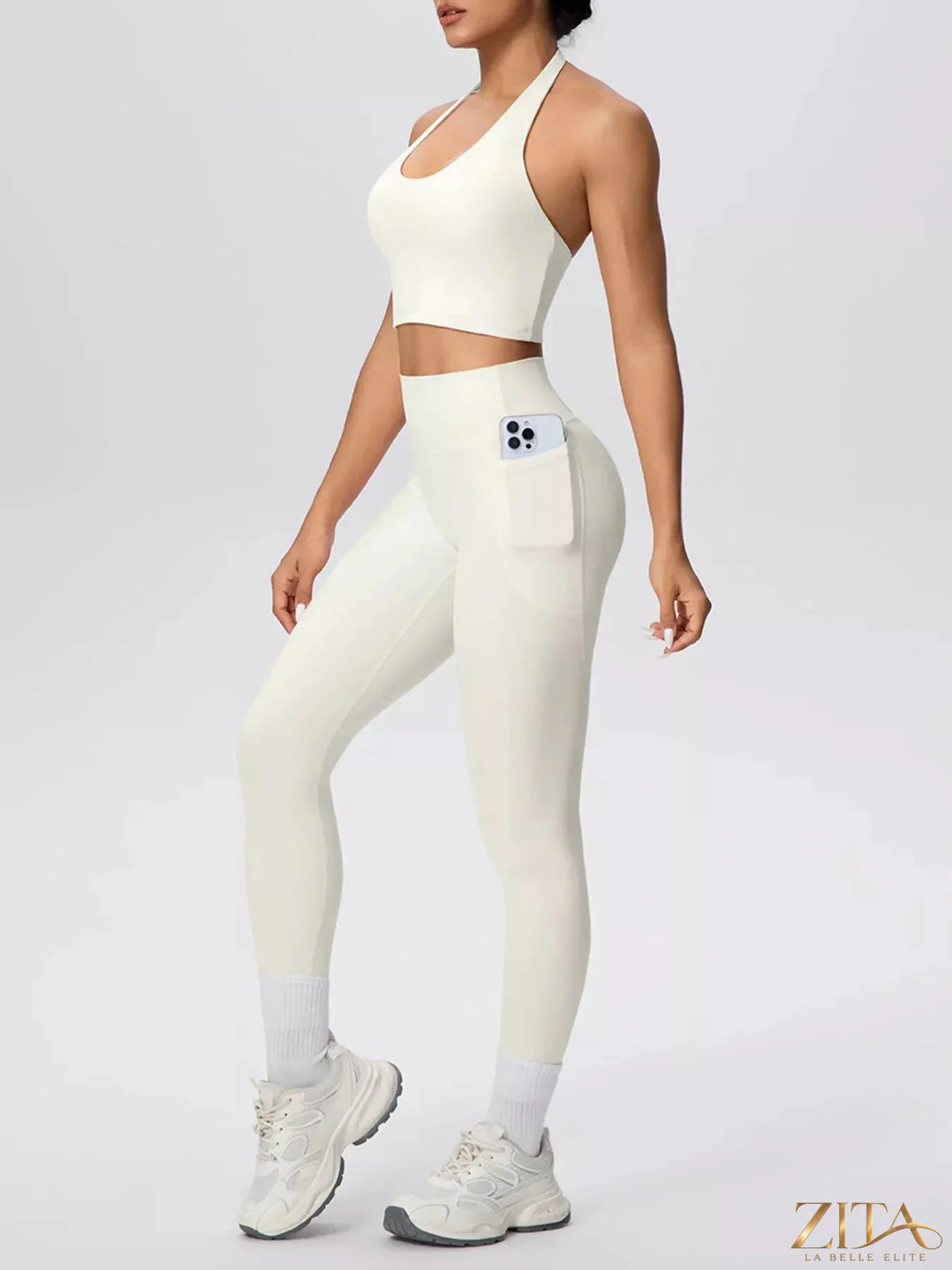 Zita La Belle Elite halter neck crop top and high-waisted leggings active set, shown in a stylish workout outfit with sleek fabric.