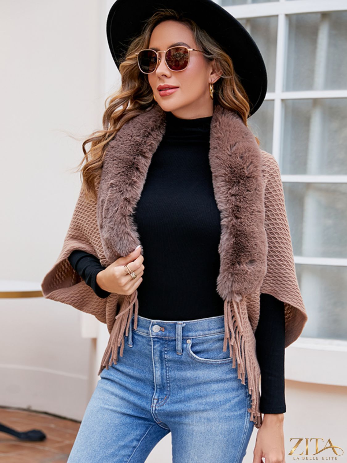 Open front fringe hem poncho by Trendsi featuring a flowing design and fringe details, perfect for layered fall outfits.