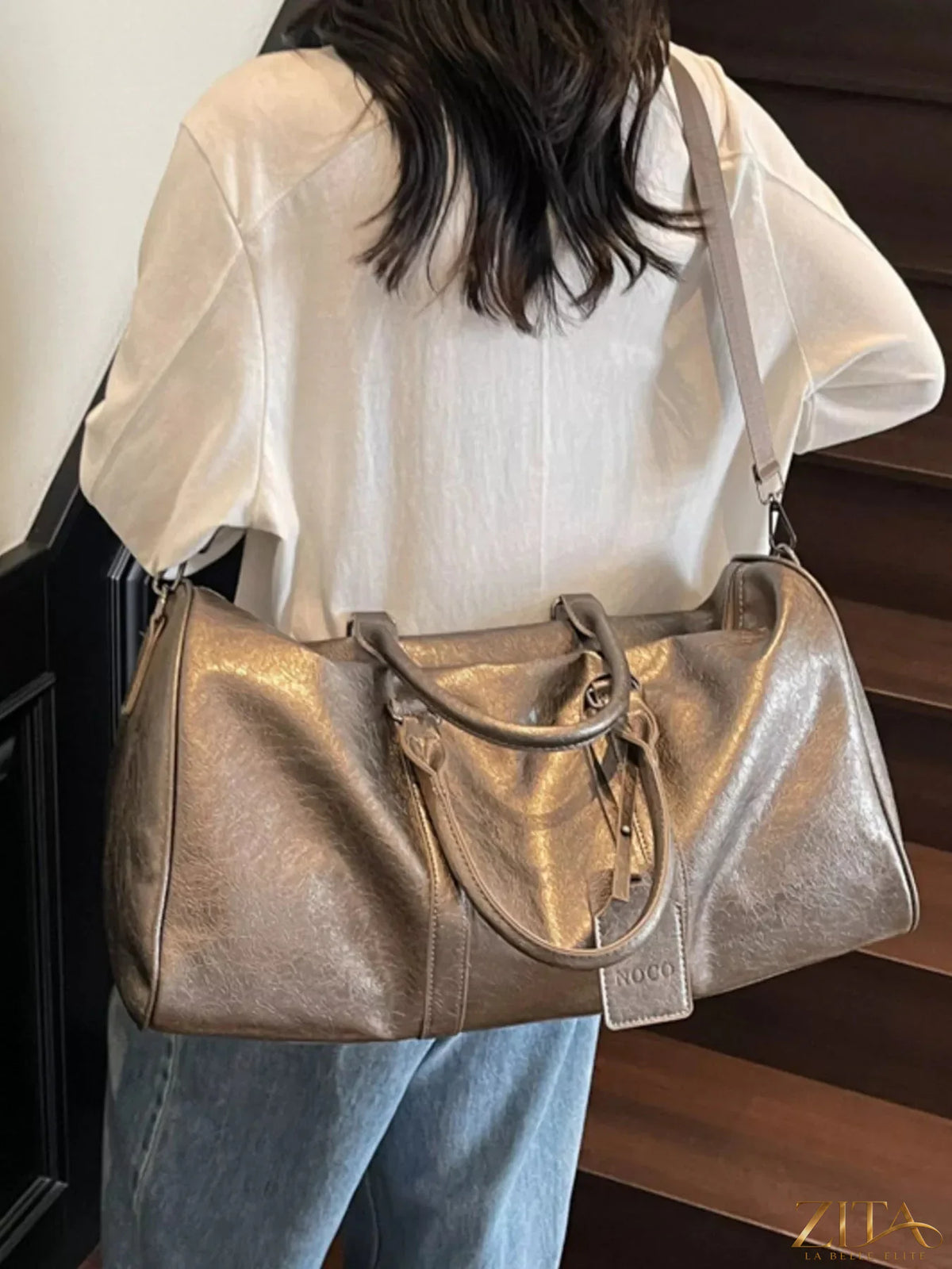 Trendsi PU leather duffle bag with sturdy handles, spacious main compartment, and sleek design for travel and everyday use.