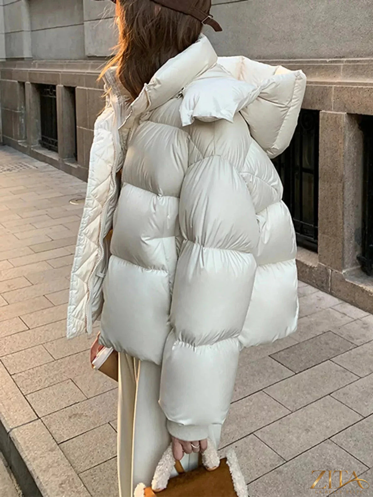 Zita La Belle Elite quilted hooded puffer jacket with shiny black quilted fabric, front zipper, and adjustable hood for warmth.