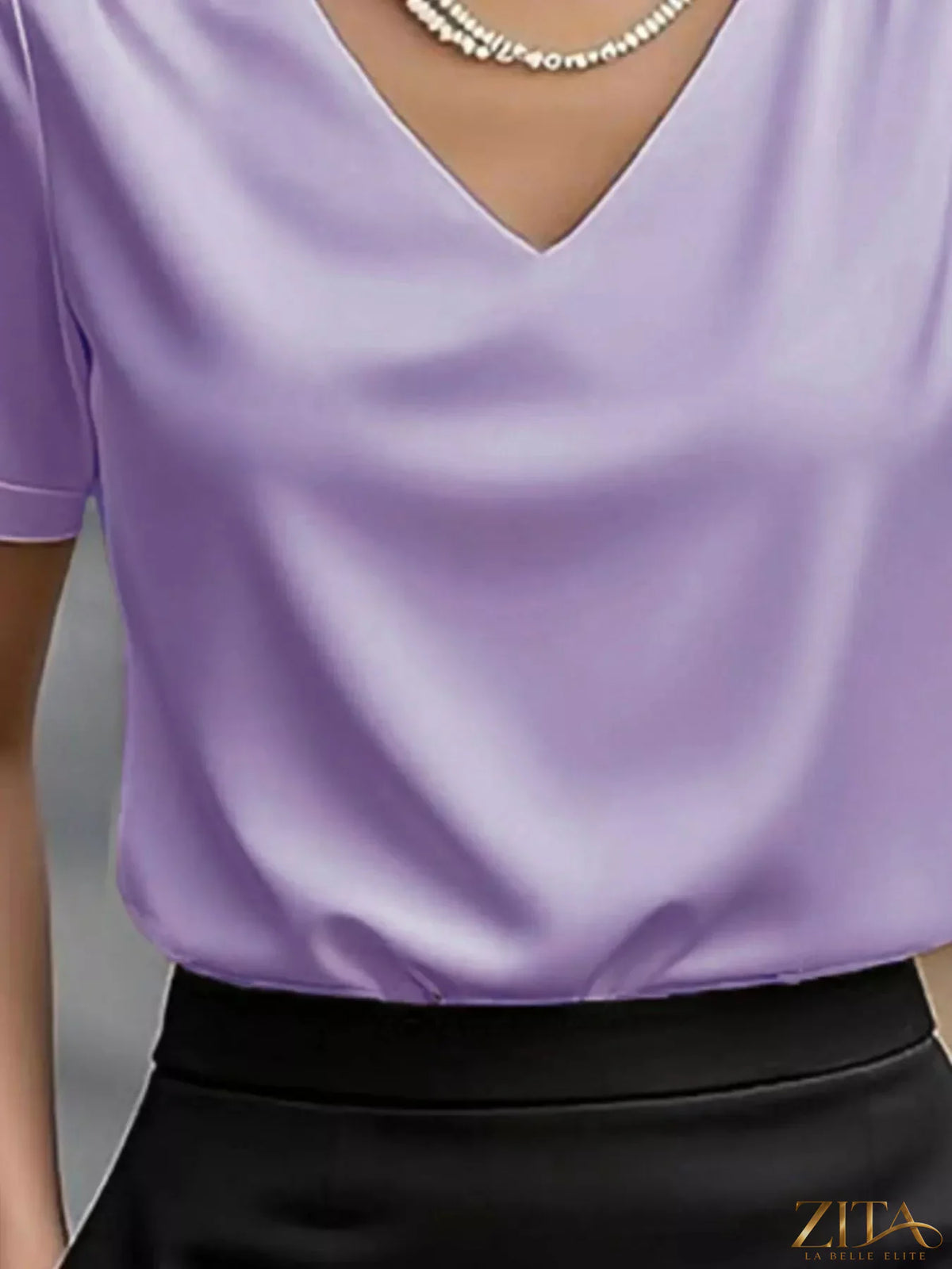 Zita La Belle Elite V-neck short sleeve satin blouse in elegant, smooth fabric with a relaxed fit and stylish design.