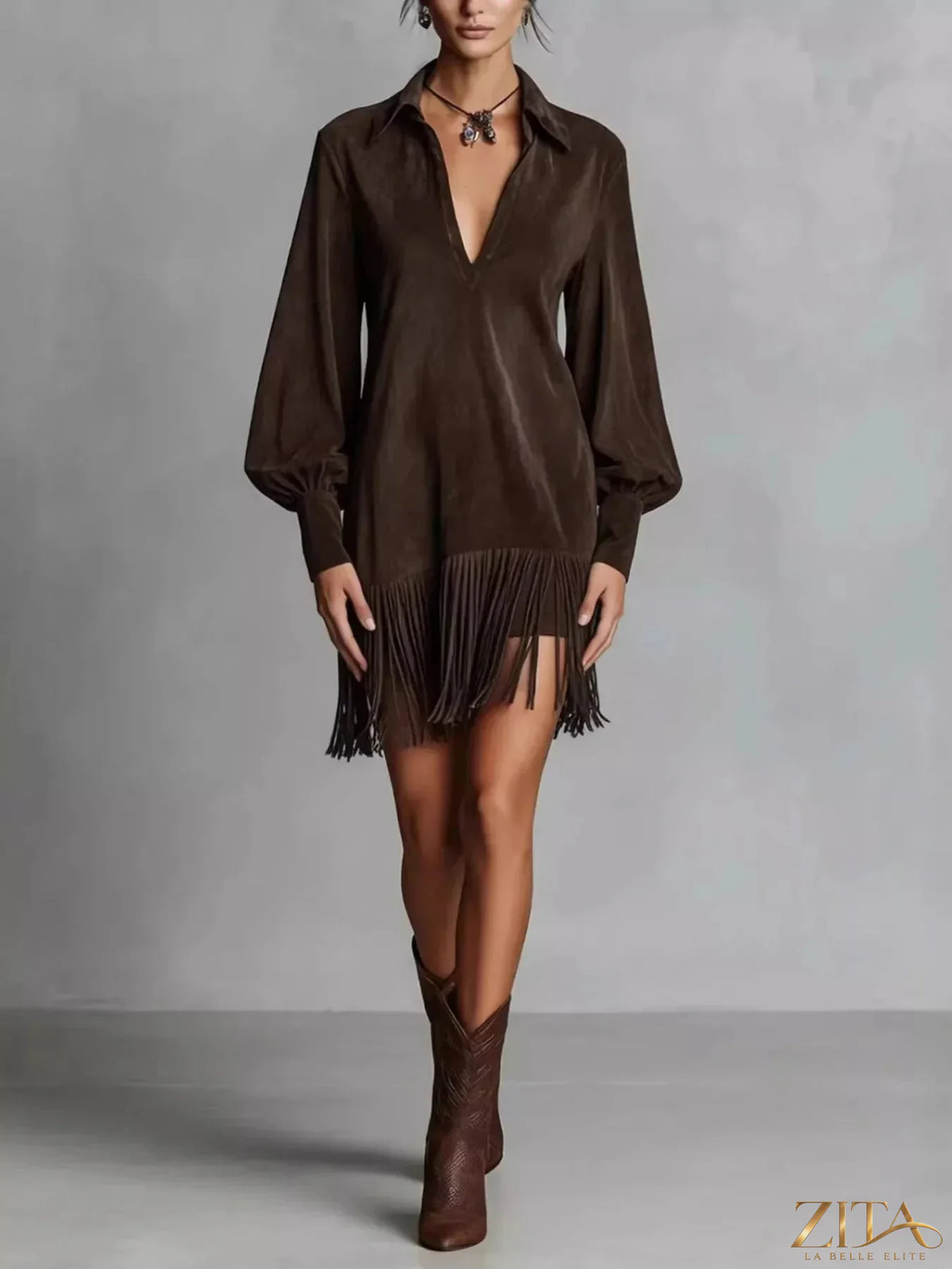 Fringed lantern sleeve dress by Trendsi featuring a stylish silhouette with flowing fabric and detailed fringe accents.