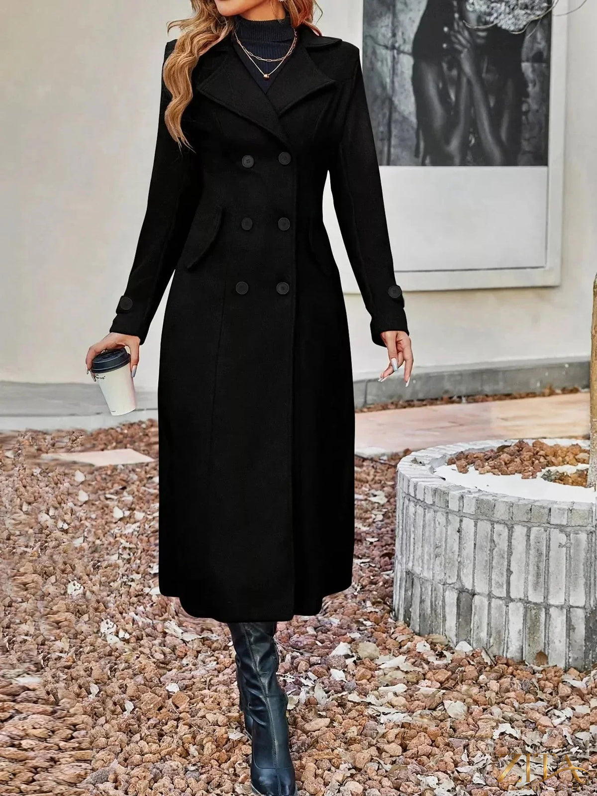 Zita La Belle Elite double-breasted longline coat in neutral fabric, displayed on a mannequin with a tailored fit and classic collar.