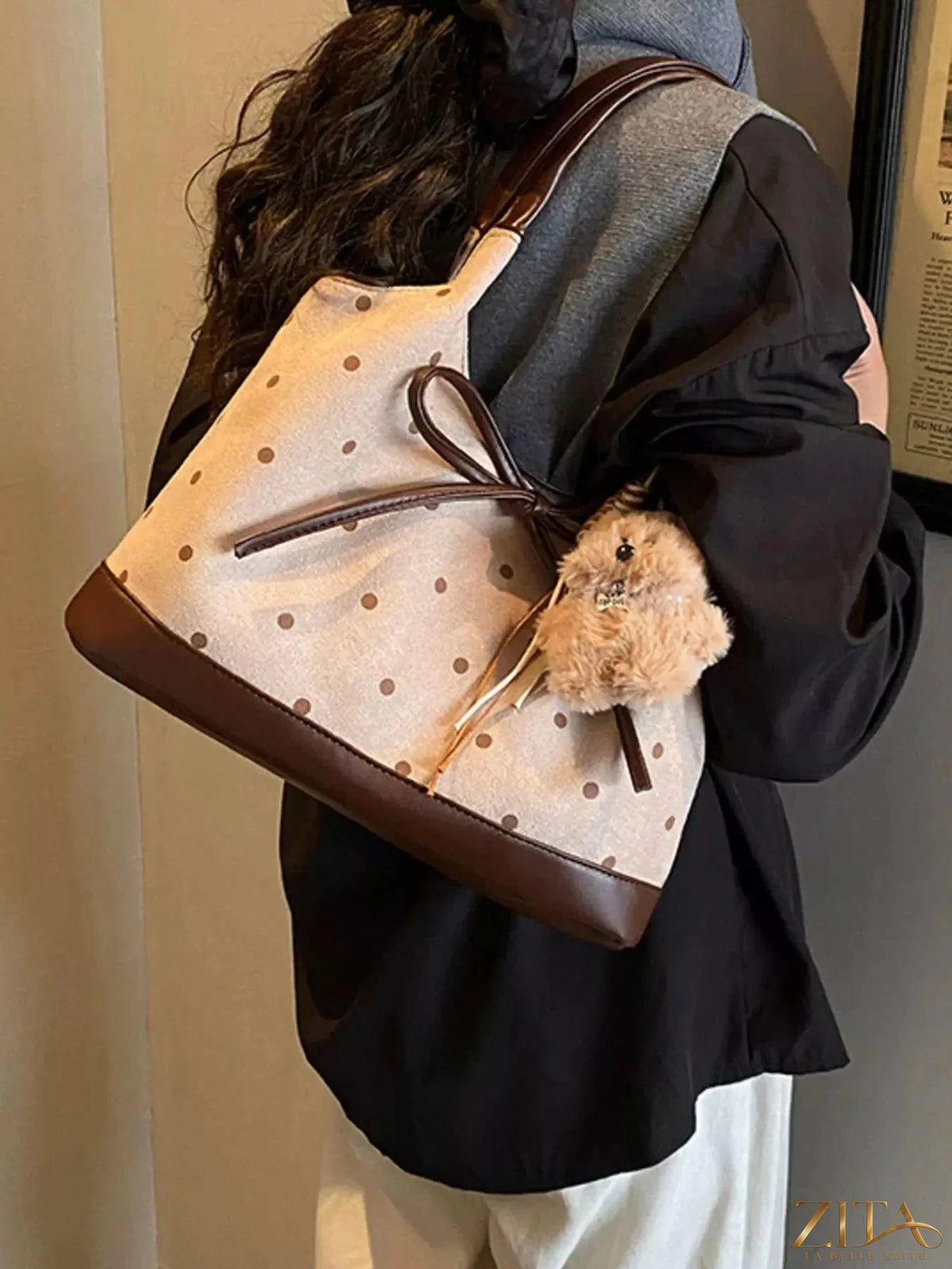 Zita La Belle Elite polka dot bow shoulder bag with black and white pattern and adjustable shoulder strap.