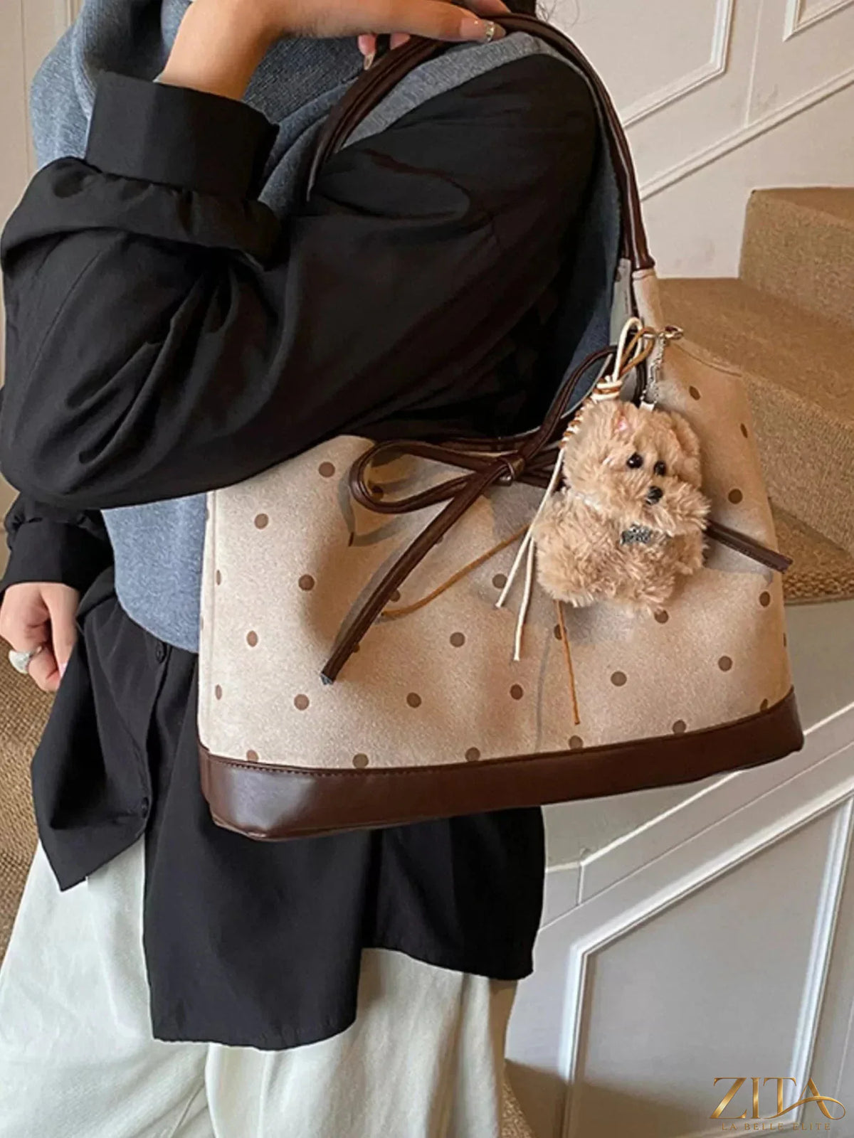 Zita La Belle Elite polka dot bow shoulder bag with top handle and adjustable strap, featuring a playful polka dot pattern and bow detail.