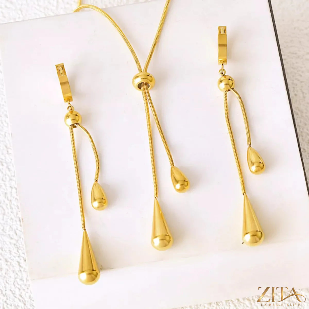 Teardrop pendant necklace and matching earrings jewelry set by Trendsi, featuring elegant teardrop-shaped charms.
