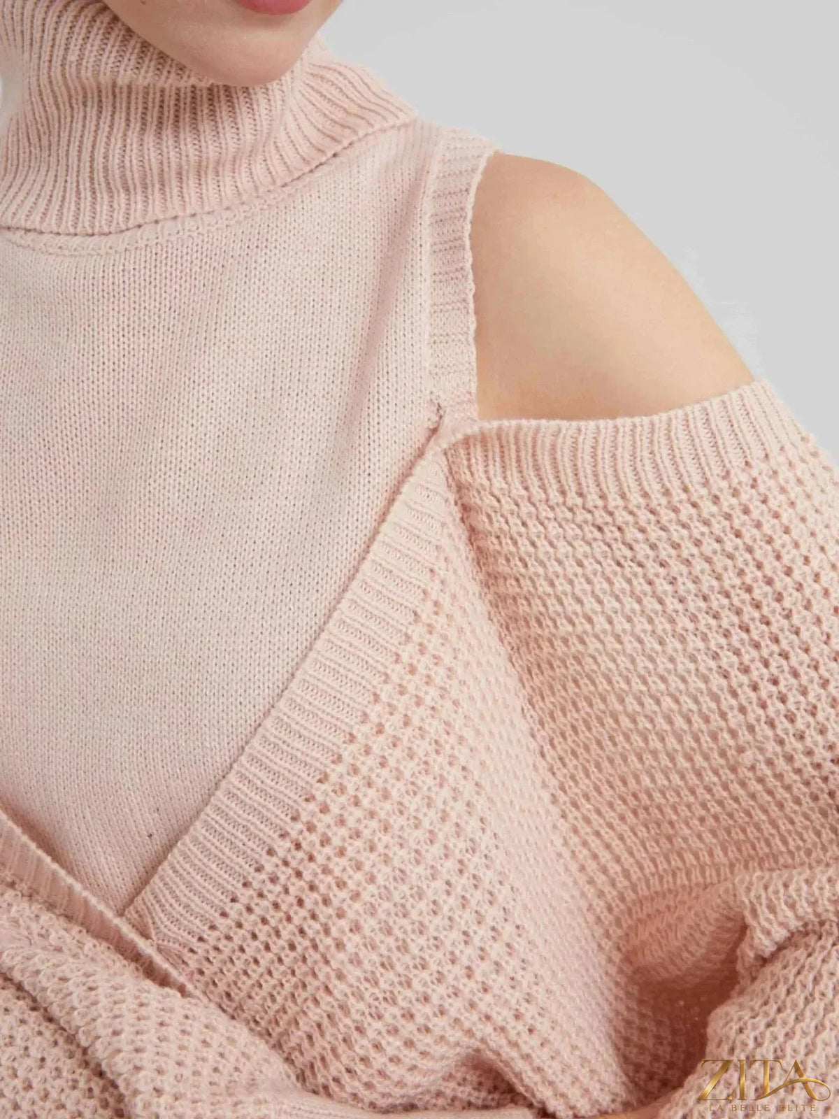Waffle knit cold shoulder turtleneck sweater by Trendsi, featuring long sleeves and cozy texture in a stylish cold-shoulder design.