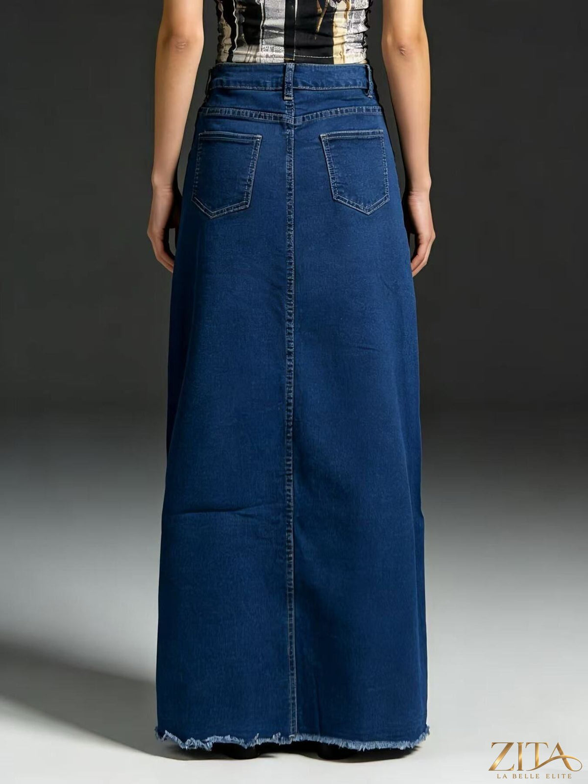 Raw hem maxi denim skirt by Zita La Belle Elite featuring a flowy silhouette and distressed detailing.