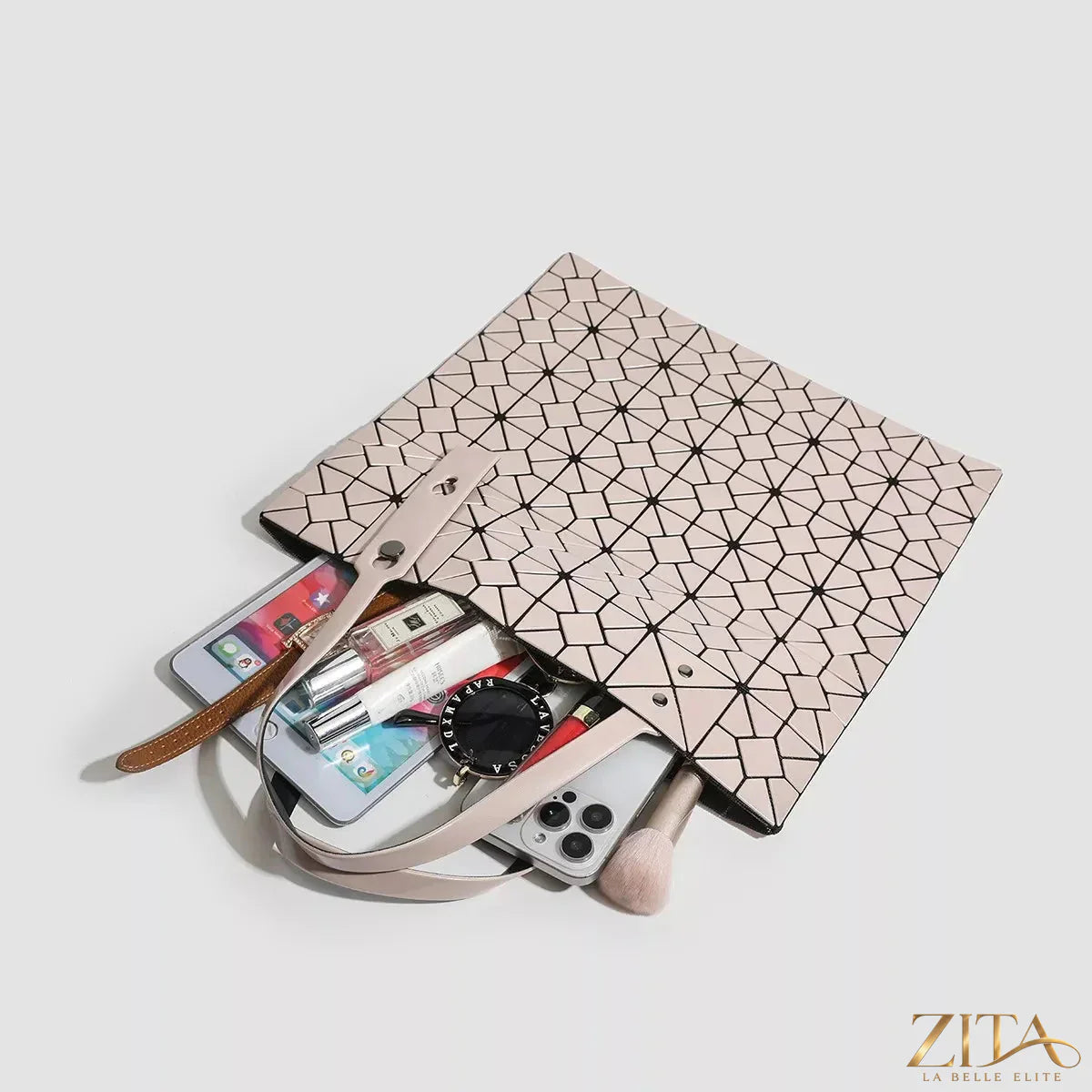 Zita La Belle Elite geometric lattice pattern handbag with sleek design and structured shape, featuring intricate cutout details.