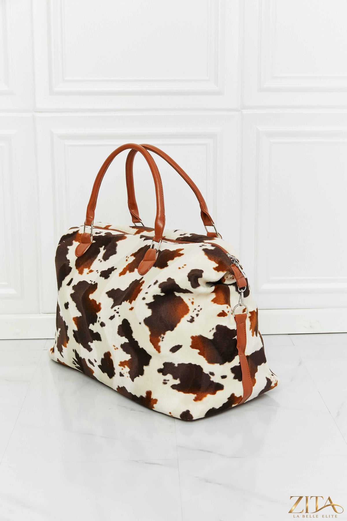 Zita La Belle Elite animal print plush weekender bag with black handles and zipper, stylish travel accessory with bold pattern