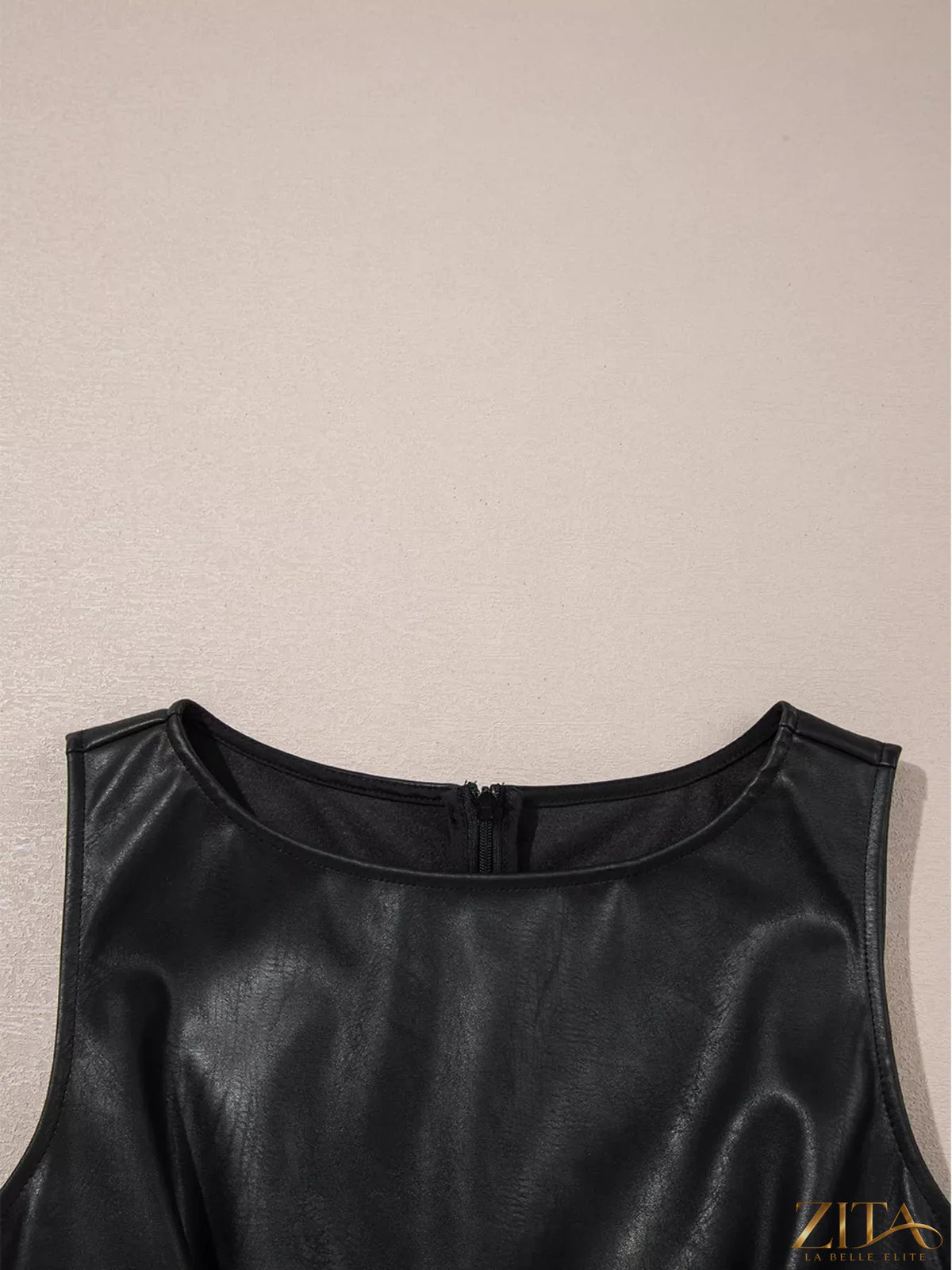 Vegan leather sleeveless mini dress by Zita La Belle Elite, showcasing a fitted design with a high neckline and sleek silhouette.
