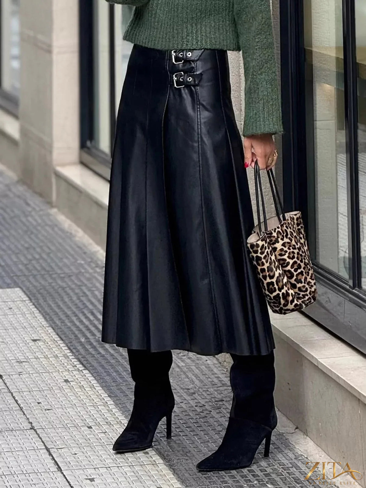 Buckle detail faux leather midi skirt from Trendsi, featuring a sleek design and stylish buckle accents on smooth black faux leather.