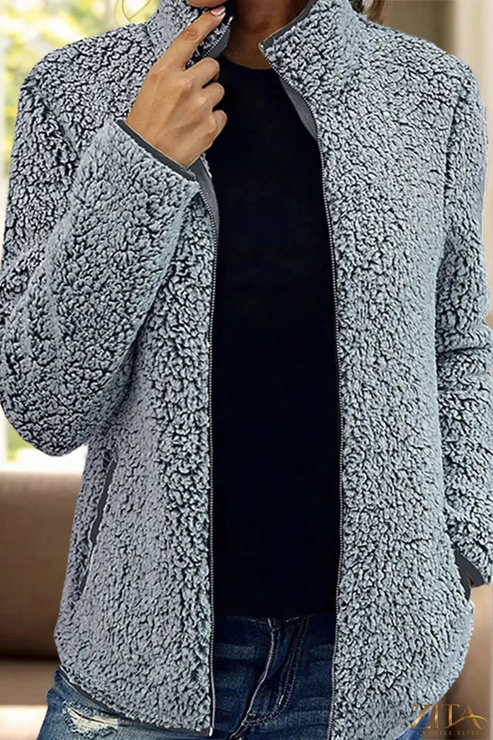 Trendsi pocketed zip-up turtleneck jacket in black, featuring a high collar, front pockets, and a fitted design.