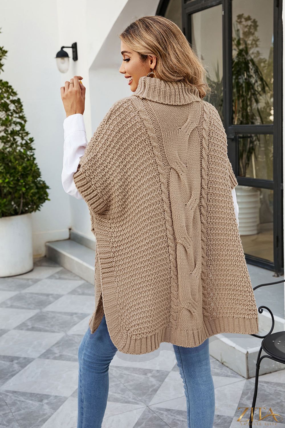 Zita La Belle Elite cable-knit turtleneck slit sweater in neutral color, featuring a cozy turtleneck and a stylish side slit.