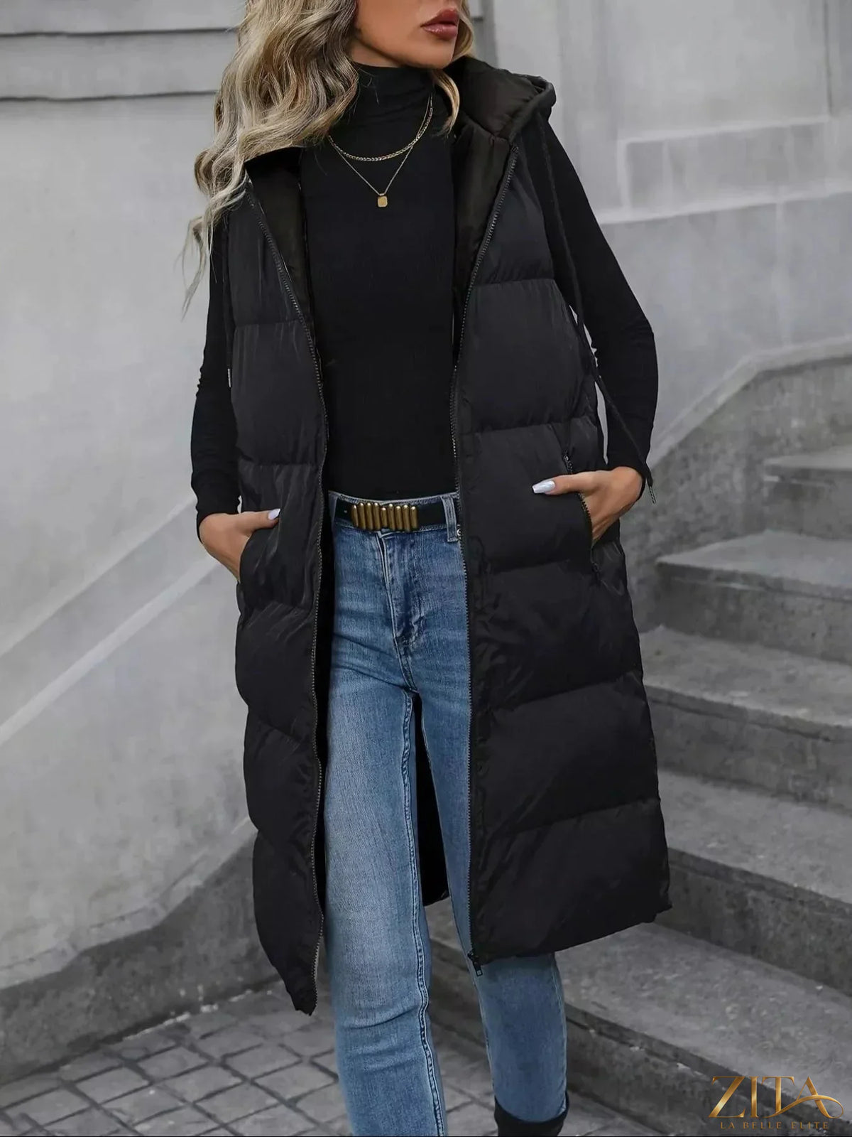 Longline padded hooded vest coat by Zita La Belle Elite, featuring a warm, quilted design and a cozy hood for winter comfort.