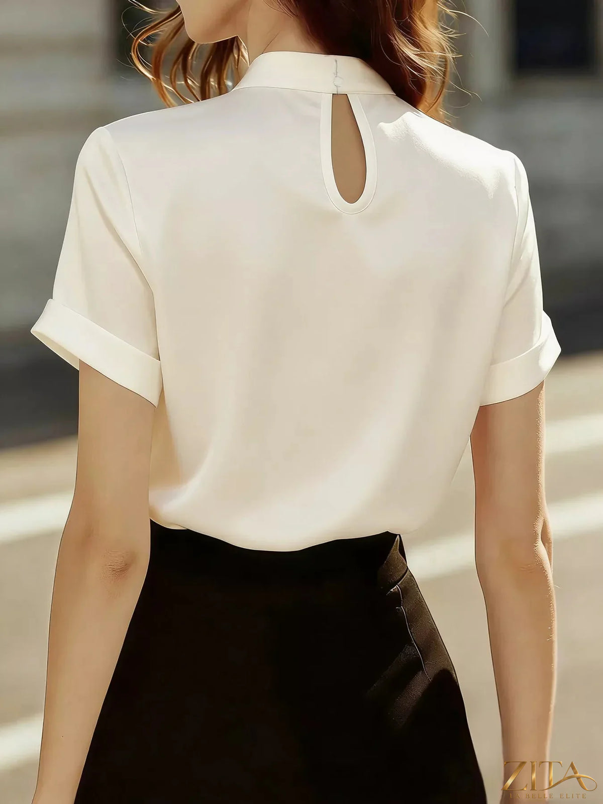 Zita La Belle Elite satin keyhole short sleeve blouse with elegant neckline and smooth fabric, styled for a chic look.