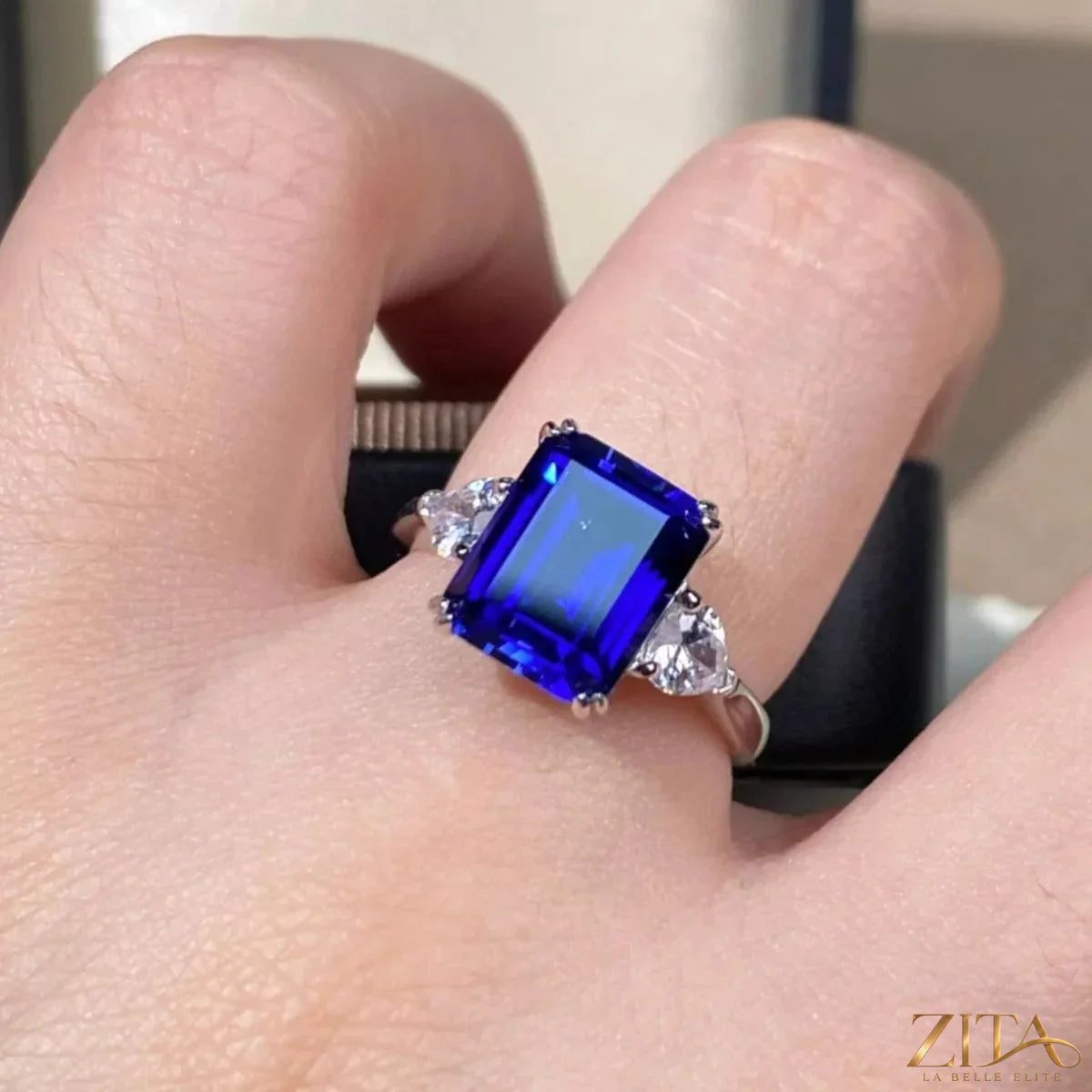 925 sterling silver ring with a geometric design and blue sapphire gemstone, showcasing elegant jewelry craftsmanship.
