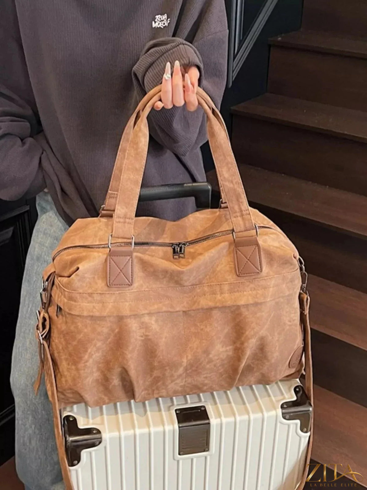 Vintage adjustable strap duffel bag by Trendsi, showing the bag's leather handles and spacious fabric interior.