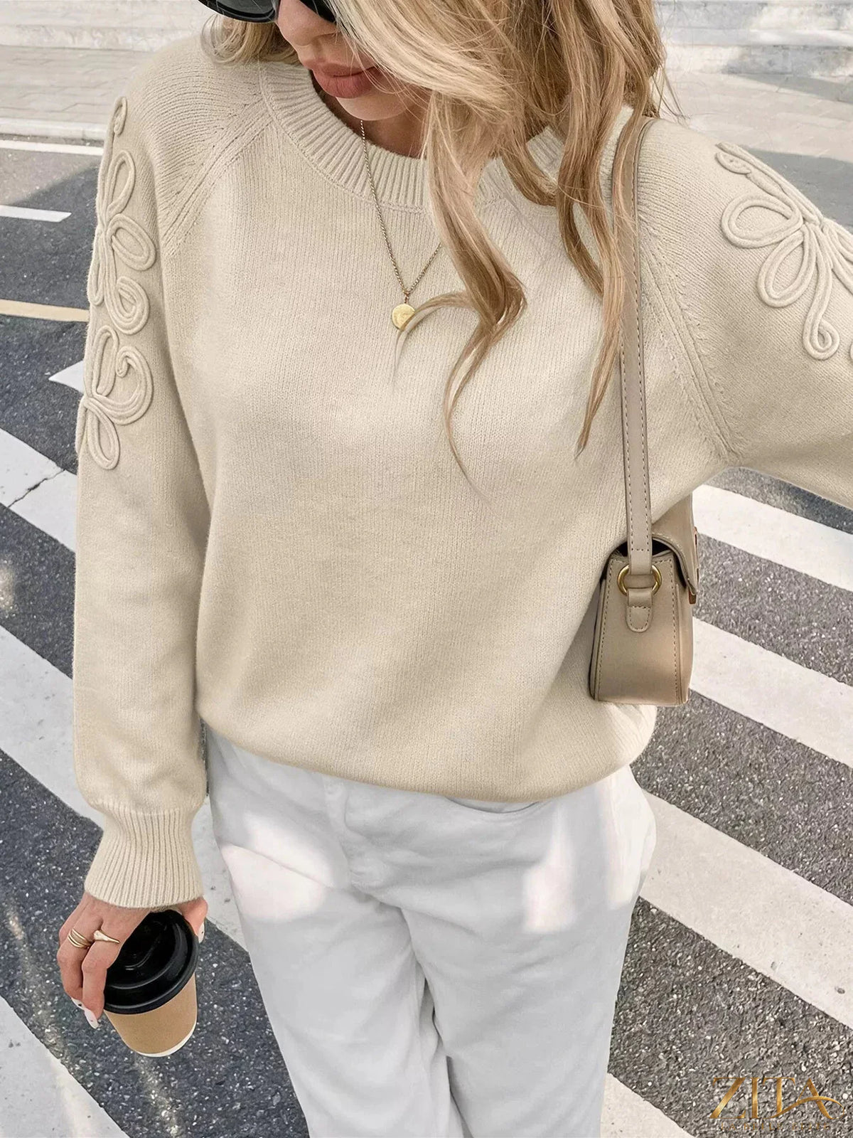 Floral raglan sleeve sweater by Trendsi featuring a cozy knit with colorful floral pattern and contrasting sleeve design.