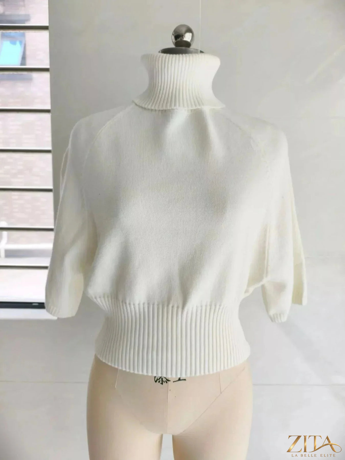 Black turtleneck batwing sleeve sweater by Trendsi, showing cozy knit fabric and relaxed fit on a mannequin.