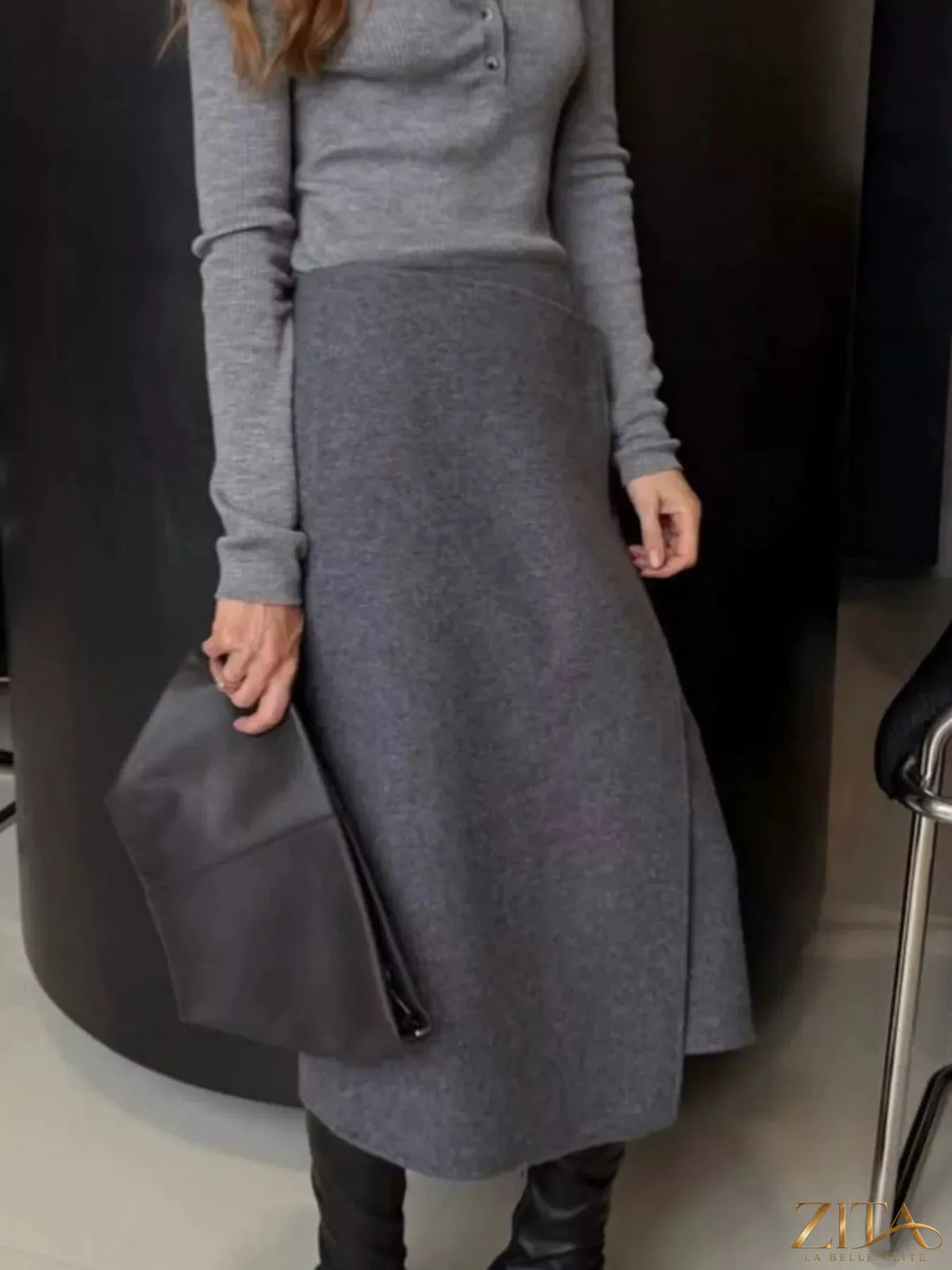 High-waisted wrap midi skirt by Trendsi, featuring a stylish design with a fitted waist and flowing hem in a versatile fabric.