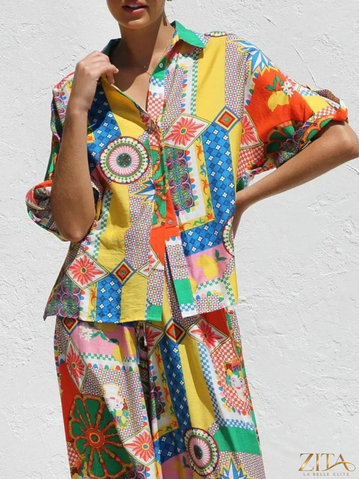 Zita La Belle Elite printed button-up shirt and matching pants set displayed on a hanger, showcasing vibrant floral pattern.