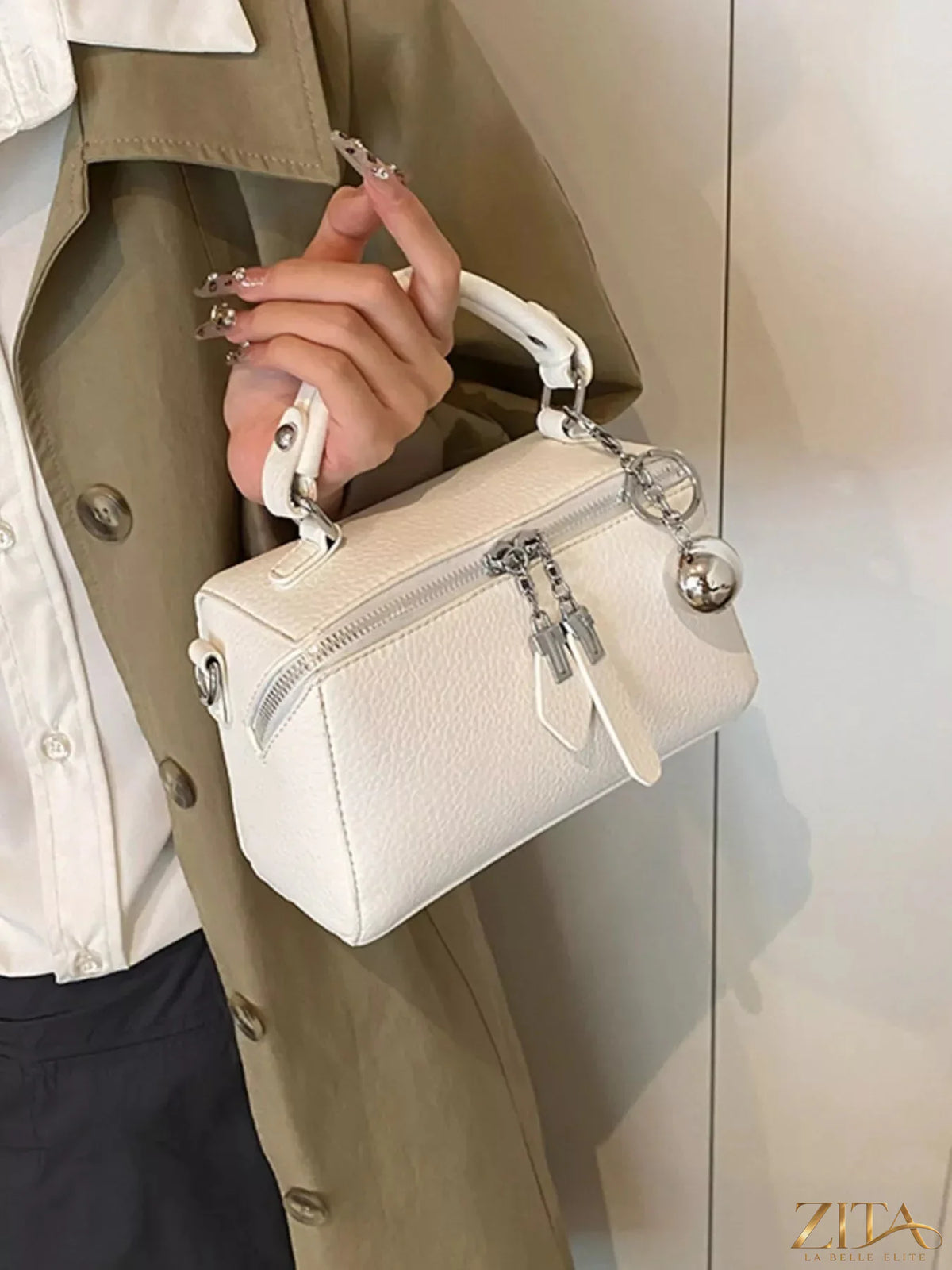 Textured leather handbag by Trendsi featuring a structured design and top handle, with gold-tone hardware and spacious interior.