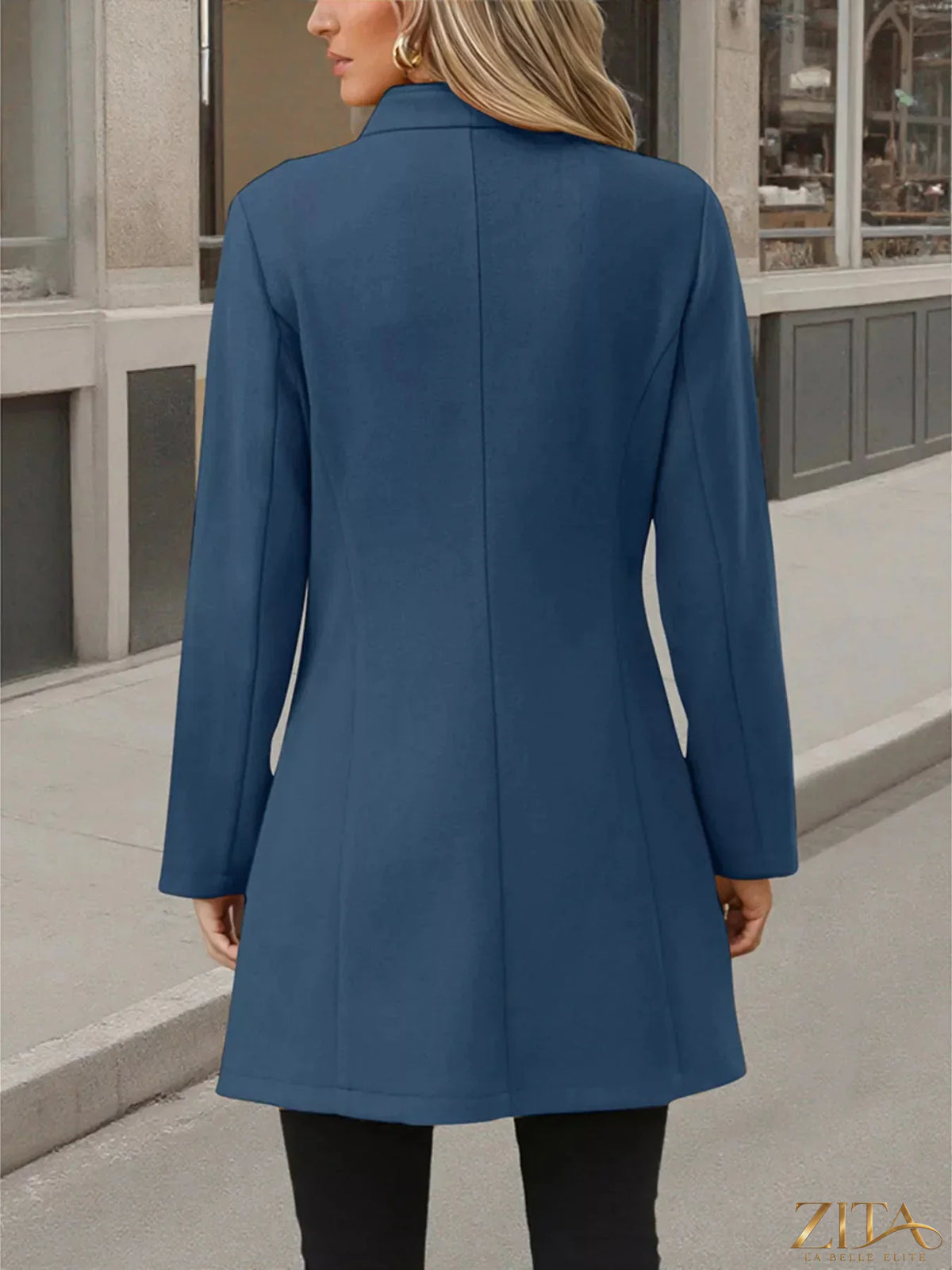 Zita La Belle Elite button-up long sleeve coat hanging on a wooden hanger, showcasing a classic tailored design.