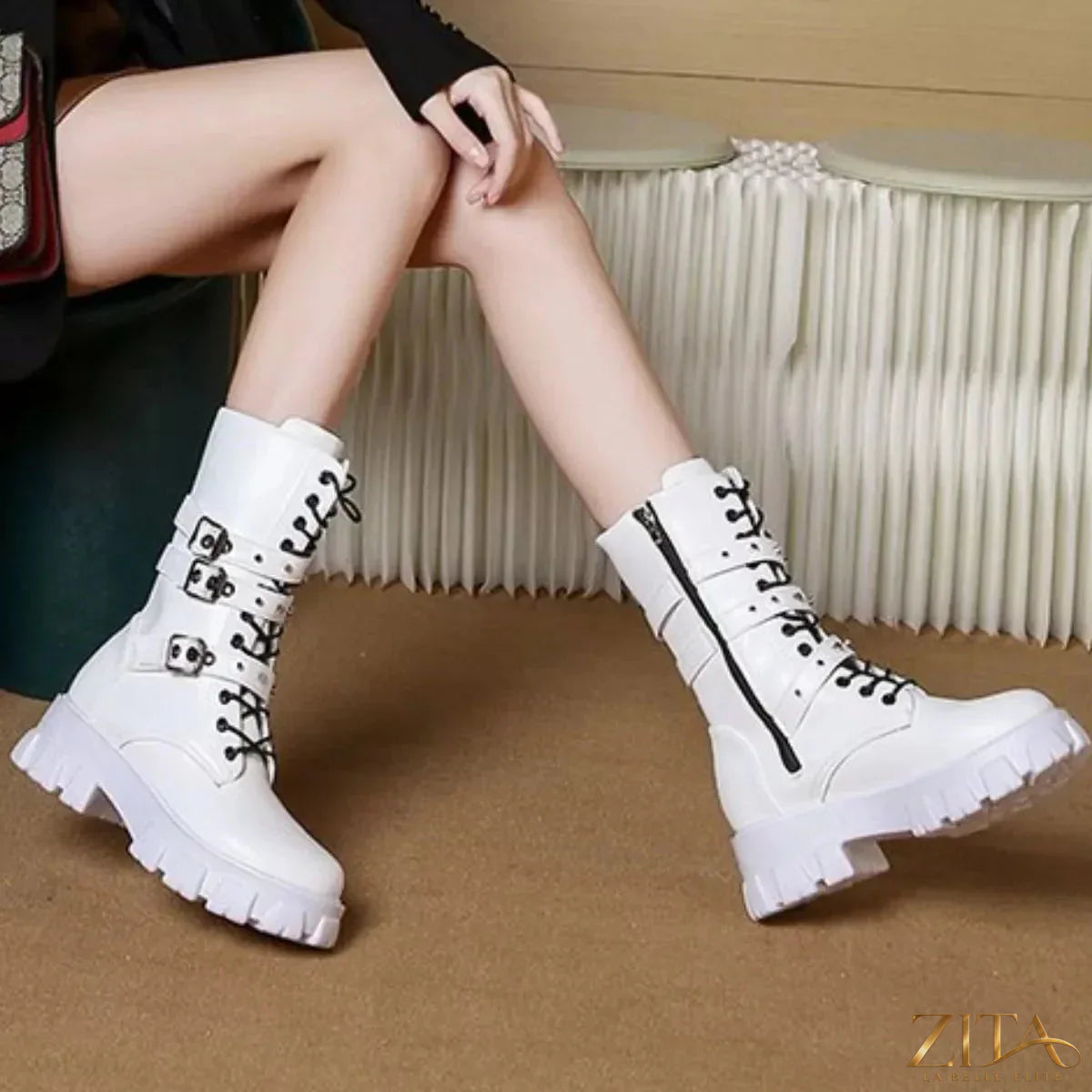 Trendsi buckled lace-up combat boots with chunky soles and metal eyelets, styled with dark leather and buckle accents.