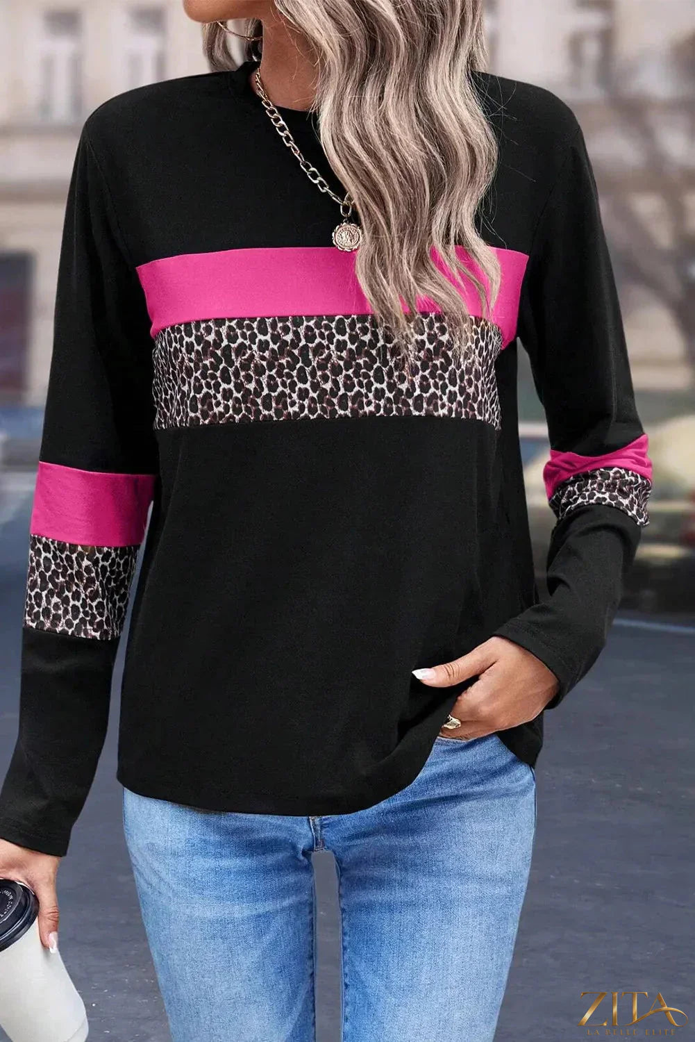 Zita La Belle Elite leopard print round neck long sleeve blouse displayed on a hanger.