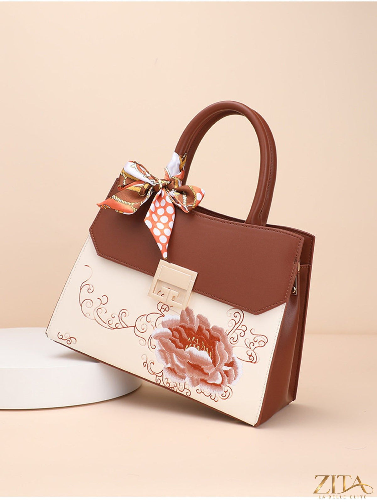 Zita La Belle Elite floral top handle handbag with colorful floral design and elegant structure.