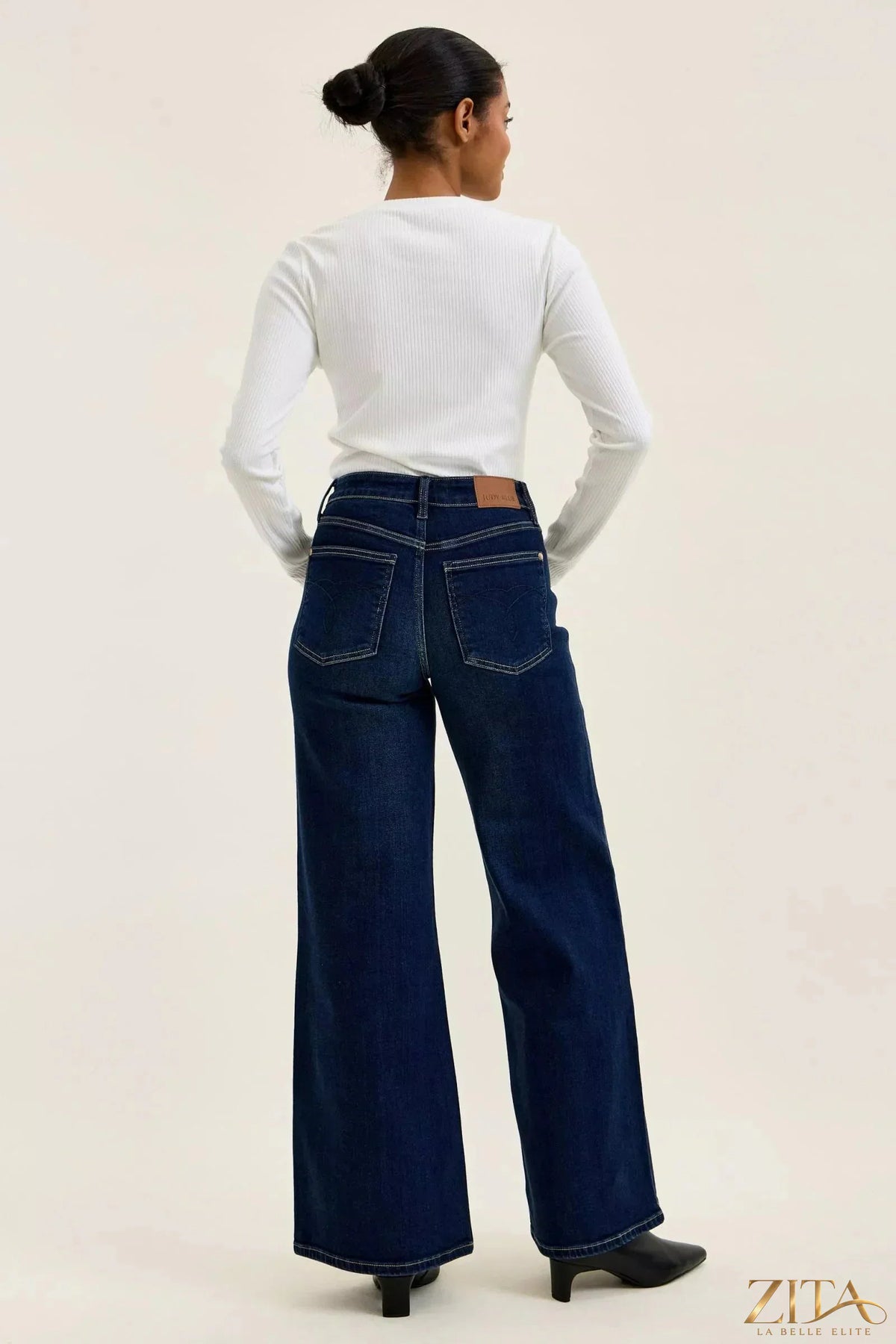 Dark wash Judy Blue high-waisted wide-leg jeans with a relaxed fit and classic denim texture, styled by Zita La Belle Elite.
